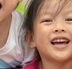 A group of kids smile & laugh together